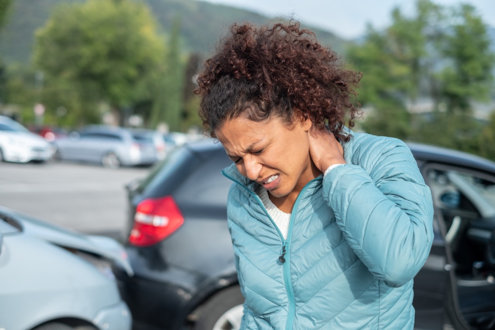 woman showing signs of whiplash after a car accident