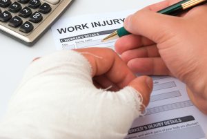 man filling out a claim after an injury at work