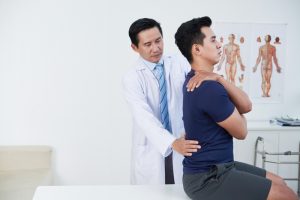 new york man getting his low back pain treated by a doctor after a car accident